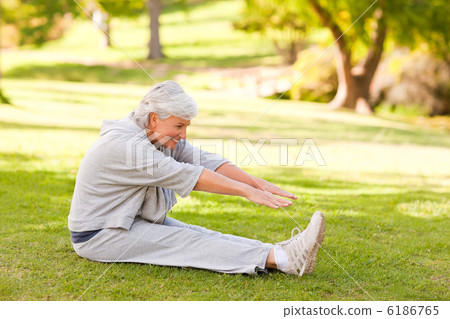 Retired woman doing her stretches in the park 6186765