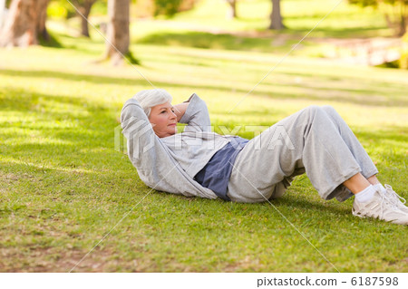 Retired woman doing her stretches in the park 6187598