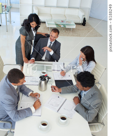 Businessteam talking about a project in a meeting Businessteam talking about a project in a meeting 6188249