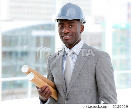 Portrait of a charismatic male architect holding blueprints 6189029