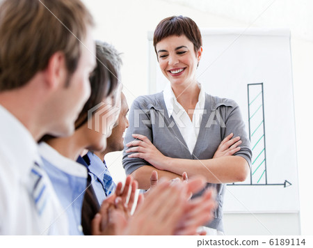 Happy business people applauding a good presentation Happy business people applauding a good presentation 6189114