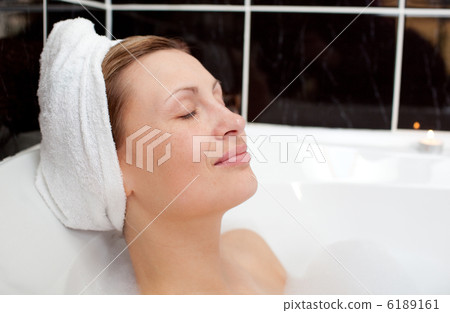 Bright woman relaxing in a bubble bath 6189161