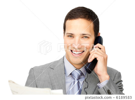 Attractive businessman on phone holding a newspaper Attractive businessman on phone holding a newspaper 6189583