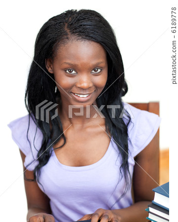 Attractive teen girl doing her homework Attractive teen girl doing her homework 6189778