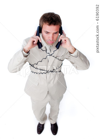 Bored businessman tangle up in phone wires Bored businessman tangle up in phone wires 6190392