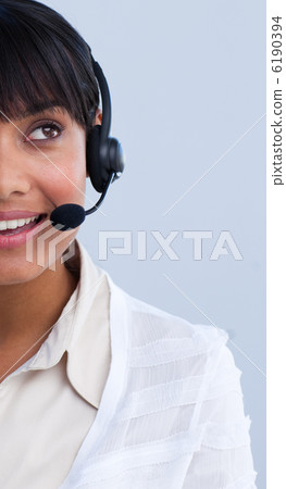 Close-up of an attractive ethnic businesswoman in a call center Close-up of an attractive ethnic businesswoman in a call center 6190394