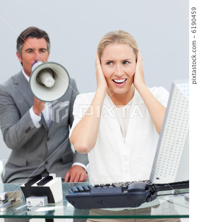 Charismatic manager yelling through a megaphone in his colleague Charismatic manager yelling through a megaphone in his colleague 6190459