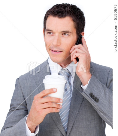 Young businessman on phone holding a drinking cup Young businessman on phone holding a drinking cup 6190675