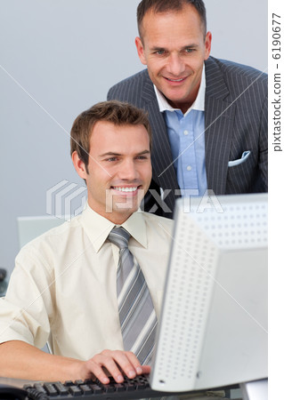 Mature manager checking his employee's work Mature manager checking his employee's work 6190677