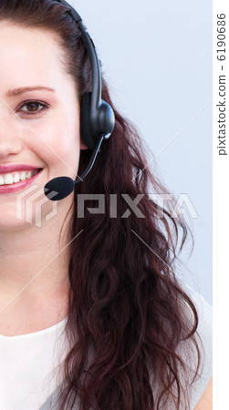 Smiling woman working with a headset on Smiling woman working with a headset on 6190686
