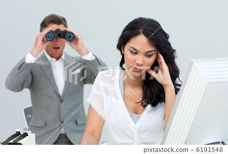 Young businesswoman getting bored and her manager looking throug Young businesswoman getting bored and her manager looking throug 6191548