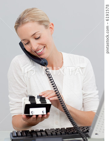 Businesswoman on phone and looking at an index holder Businesswoman on phone and looking at an index holder 6191578