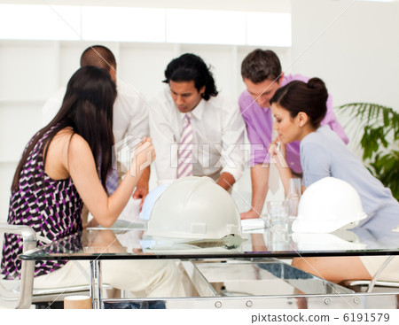International architect co-workers reviewing blueprints International architect co-workers reviewing blueprints 6191579