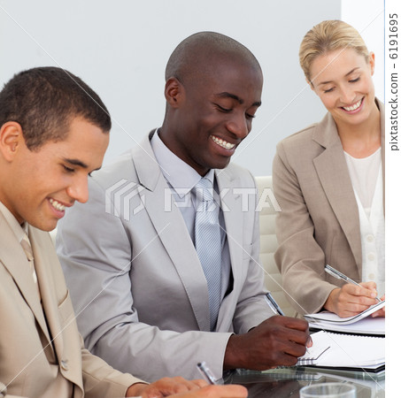 Business People Smiling in a meeting Business People Smiling in a meeting 6191695