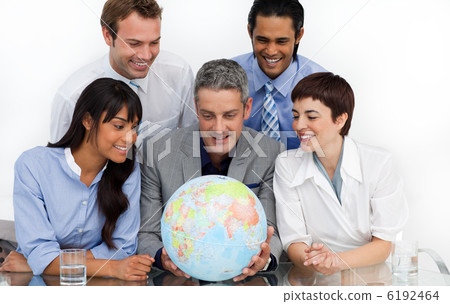 Smiling business people looking at a terrestrial globe Smiling business people looking at a terrestrial globe 6192464