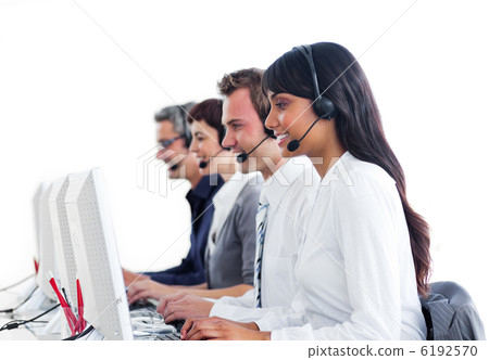 Concentrated customer service representatives with headset on Concentrated customer service representatives with headset on 6192570