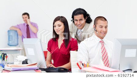 Businessman on phone by the watercooler Businessman on phone by the watercooler 6192714