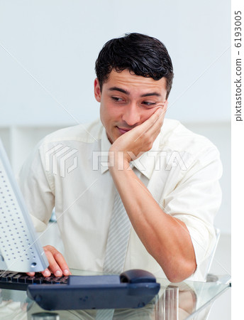 Bored young businessman at his desk 6193005