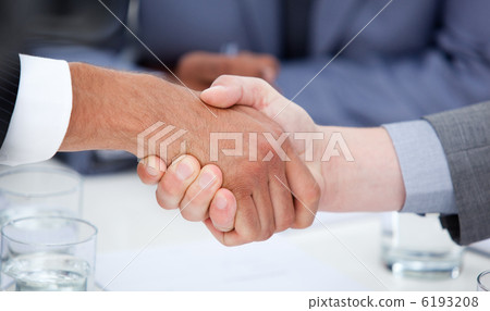 Close-up of confident business people closing a deal 6193208