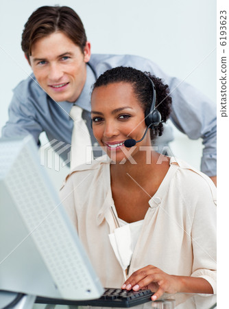 Attractive manager checking his employee's work 6193623