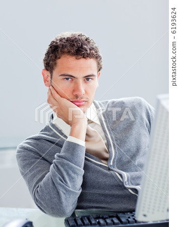 Portrait of a young businessman getting bored at work Portrait of a young businessman getting bored at work 6193624