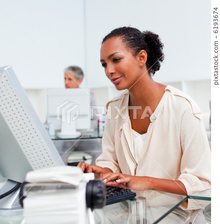 Concentrated businesswoman working at a computer 6193674