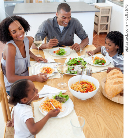 Smiling family dining together 6193676