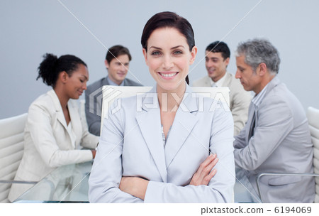 Confident businesswoman smiling in a meeting Confident businesswoman smiling in a meeting 6194069