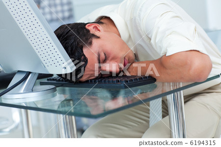 Tired businessman sleeping at his desk Tired businessman sleeping at his desk 6194315