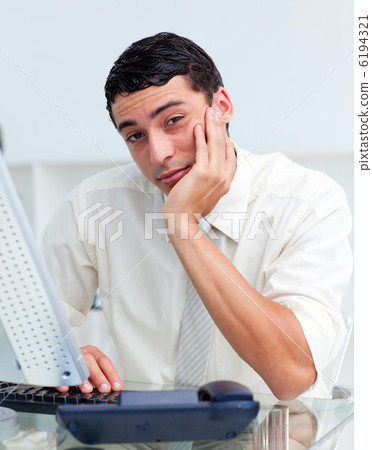 Bored Hispanic businessman at his desk 6194321