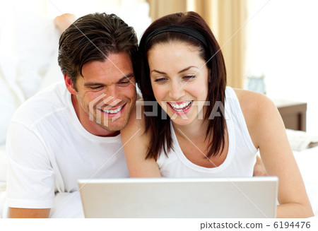 Romantic couple using laptop Romantic couple using laptop 6194476