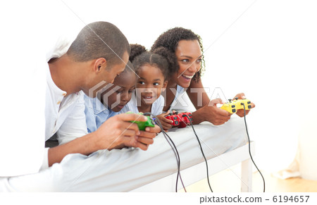 Lively family playing video game lying down on bed 6194657