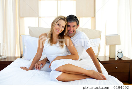 Affectionate lovers embracing on bed 6194992