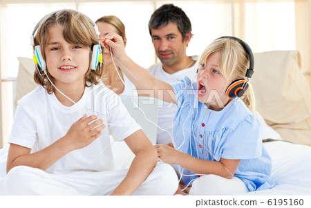 Merry children having fun and listening music 6195160