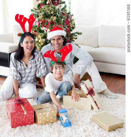 Family decorating a Christmas tree 6195168