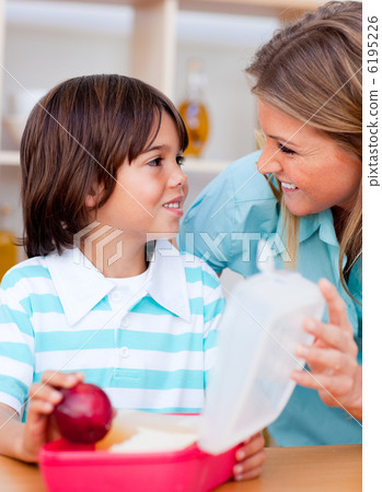 Joyful little boy and his mother preparing his snack Joyful little boy and his mother preparing his snack 6195226