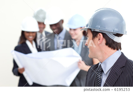 Engineer looking at his team in the background 6195253