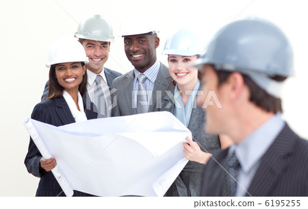 Engineer smiling at his team in the background 6195255