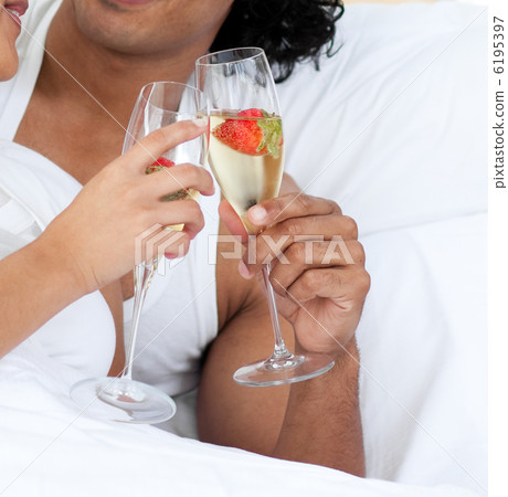 Close-up of lovers toasting with Champagne and strawberries Close-up of lovers toasting with Champagne and strawberries 6195397