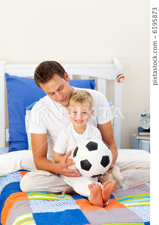 Cute little boy and his father playing with a soccer ball Cute little boy and his father playing with a soccer ball 6195873