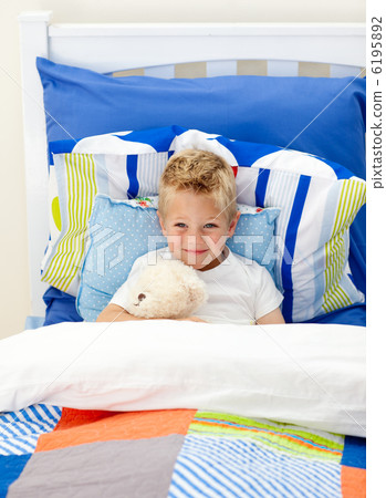 Adorable little boy lying in bed Adorable little boy lying in bed 6195892