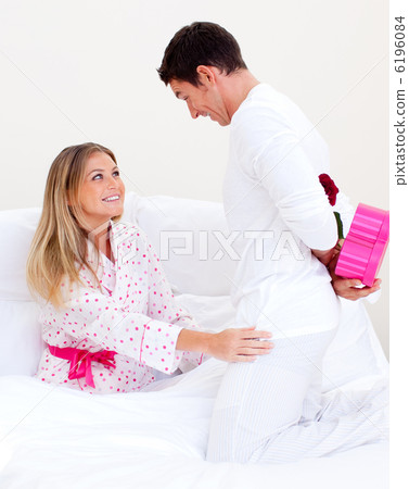 Lovely husband giving a present to his wife Lovely husband giving a present to his wife 6196084