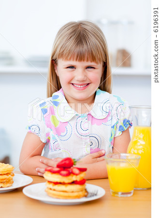 Joyful little girl eating waffles with strawberries Joyful little girl eating waffles with strawberries 6196391