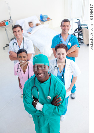 High angle of smling medical team with a child patient High angle of smling medical team with a child patient 6196417