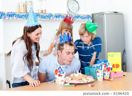 Elegant man celebrating his birthday with his wife and his child 6196420
