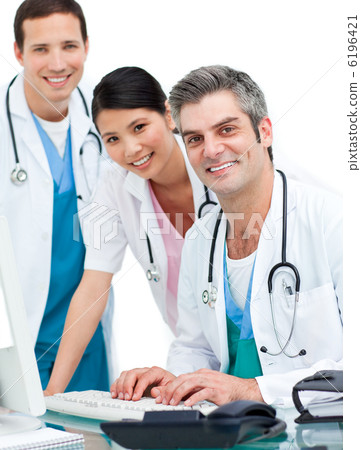 Medical team working at a computer Medical team working at a computer 6196421