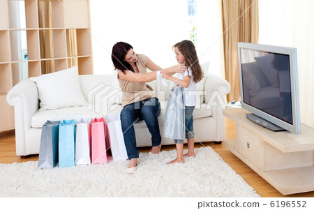 Joyful mother and her daughter at home after shopping 6196552