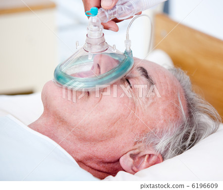 Senior patient receiving oxygen mask 6196609