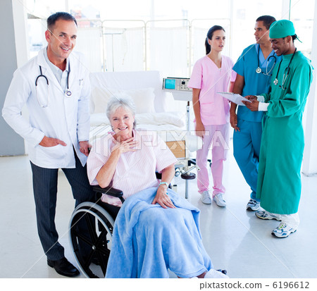 Positive medical team taking care of a senior woman 6196612