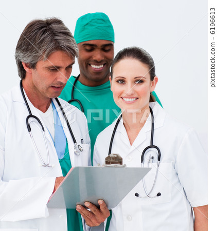 Portrait of medical team taking notes Portrait of medical team taking notes 6196613
